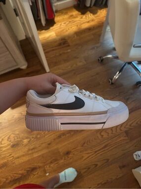 Nike White Low-Top Sneaker with Black Swoosh and Tan Accent
